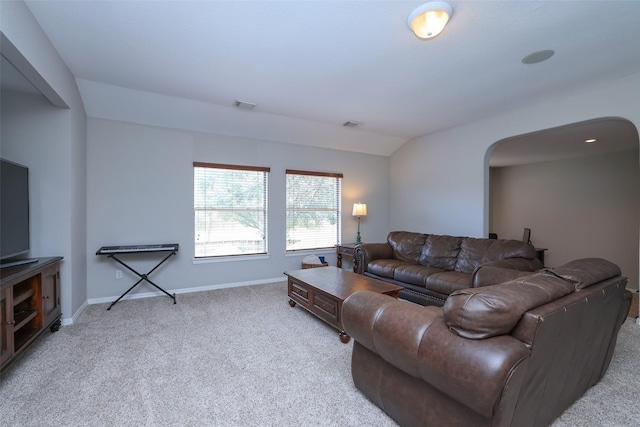 living room with light colored carpet and lofted ceiling