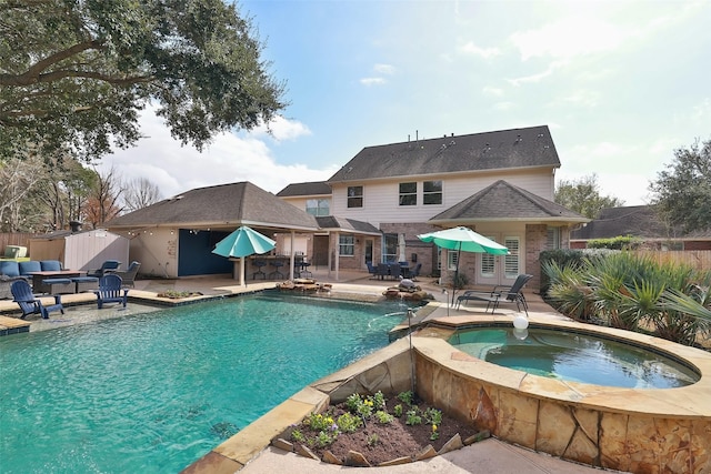 view of swimming pool with an in ground hot tub and a patio