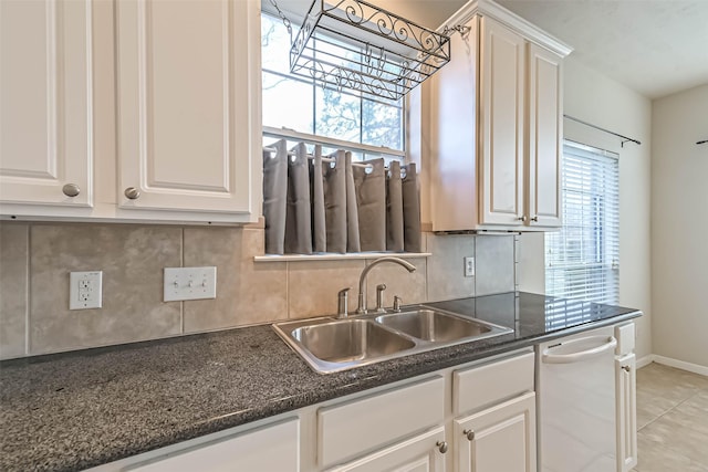 kitchen featuring white cabinetry, sink, and a healthy amount of sunlight