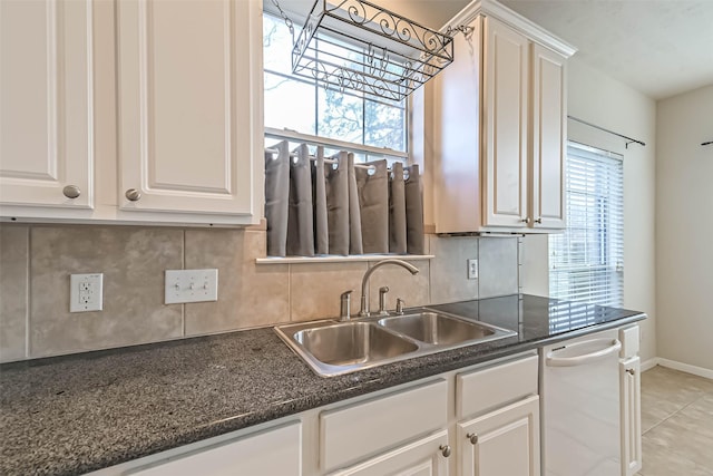 1408 S Friendswood Dr Unit 101, Friendswood, TX 77546 - kitchen with a sink, white dishwasher, dark countertops, backsplash, and white cabinets