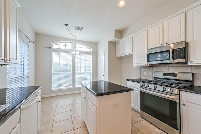 kitchen with white cabinetry, stainless steel appliances, and a center island