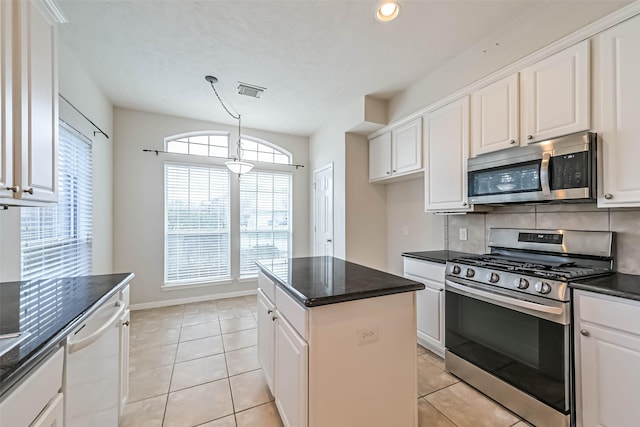 1408 S Friendswood Dr Unit 101, Friendswood, TX 77546 - kitchen featuring appliances with stainless steel finishes, white cabinetry, tasteful backsplash, and recessed lighting