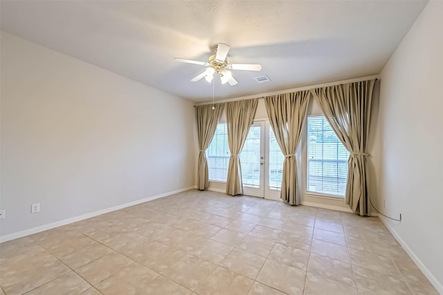 spare room with french doors, ceiling fan, and light tile patterned floors