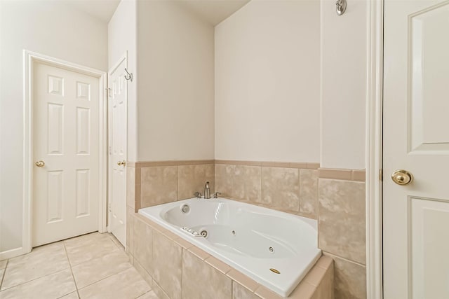 bathroom featuring tile patterned flooring and tiled bath