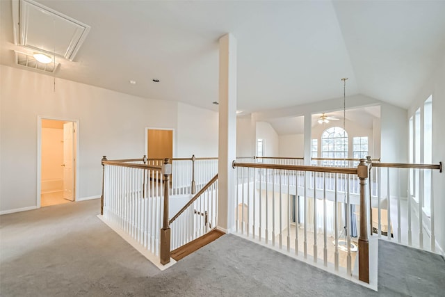 1408 S Friendswood Dr Unit 101, Friendswood, TX 77546 - hall with attic access, vaulted ceiling, carpet, baseboards, and an upstairs landing