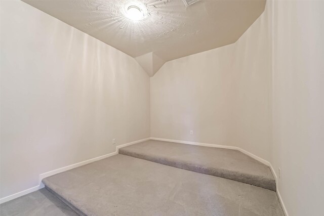1408 S Friendswood Dr Unit 101, Friendswood, TX 77546 - bonus room with carpet, baseboards, and vaulted ceiling