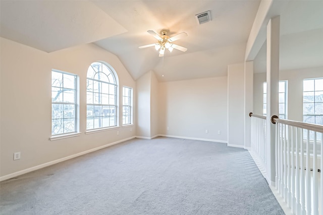 spare room featuring ceiling fan, vaulted ceiling, and carpet