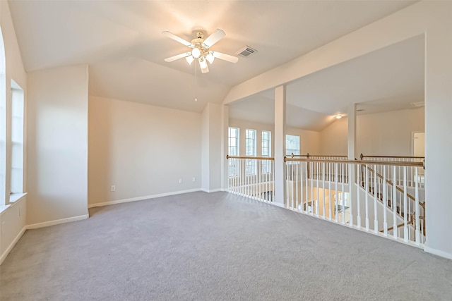 empty room featuring lofted ceiling, carpet floors, and ceiling fan