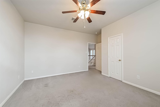 carpeted spare room with ceiling fan