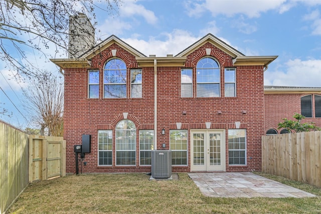 back of property featuring french doors, a yard, central AC unit, and a patio