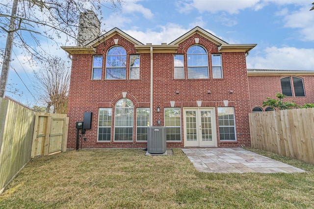 back of house featuring a patio, a yard, central AC unit, and french doors