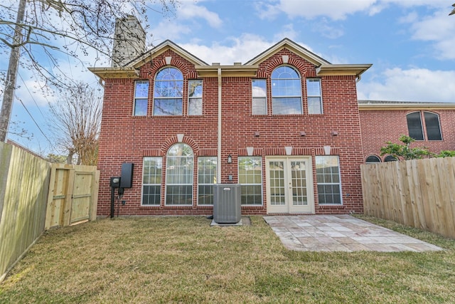 1408 S Friendswood Dr Unit 101, Friendswood, TX 77546 - back of property with cooling unit, brick siding, a chimney, a patio area, and french doors