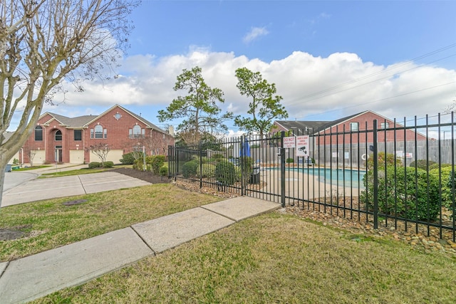 exterior space with a community pool and a yard