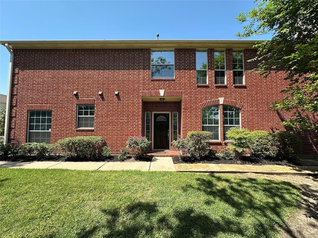 1408 S Friendswood Dr Unit 101, Friendswood, TX 77546 - view of front facade featuring a front lawn and brick siding