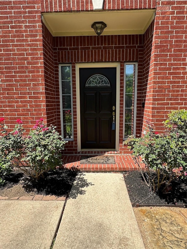 entrance to property with brick siding