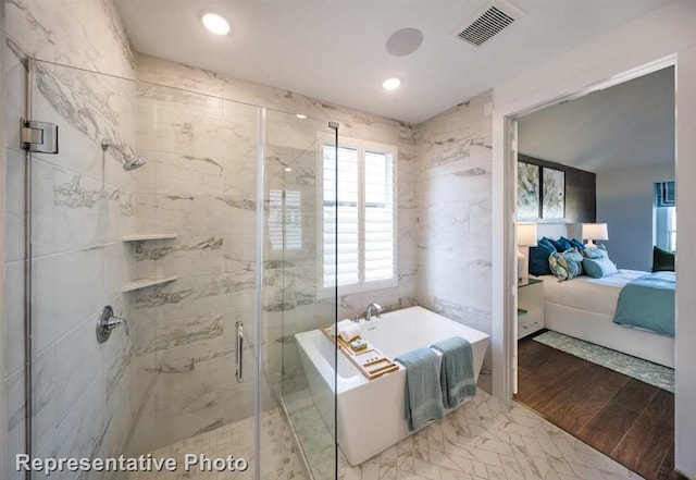 bathroom featuring a stall shower, connected bathroom, a washtub, visible vents, and wood finished floors