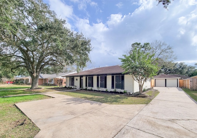 ranch-style house with an outbuilding, a garage, and a front yard