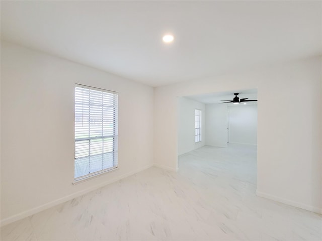 spare room featuring a wealth of natural light and ceiling fan