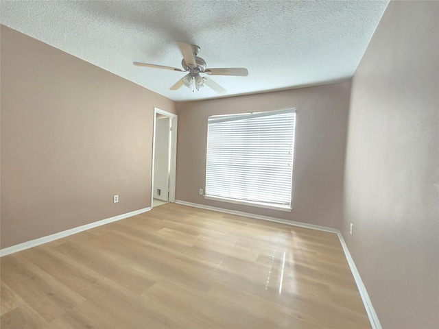 spare room featuring a textured ceiling, light hardwood / wood-style flooring, and ceiling fan