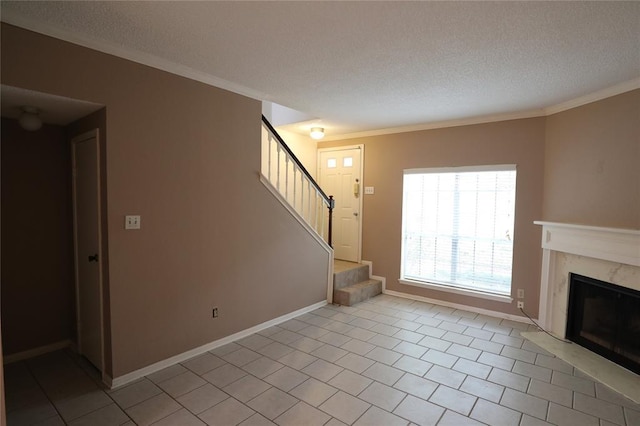 unfurnished living room featuring ornamental molding, a premium fireplace, a textured ceiling, and light tile patterned flooring