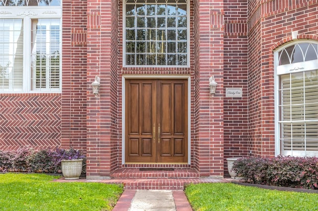 doorway to property featuring brick siding