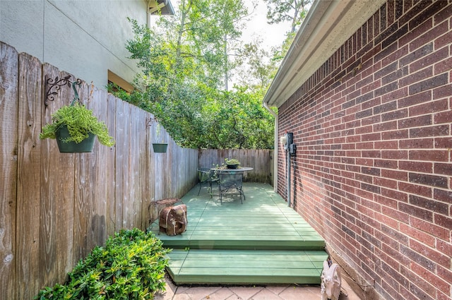 deck with outdoor dining space and fence