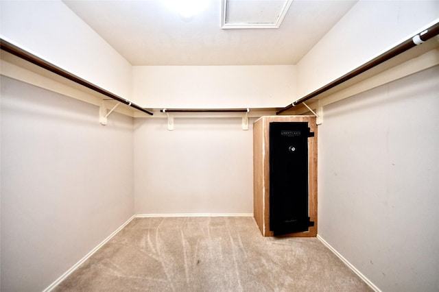 walk in closet featuring light colored carpet