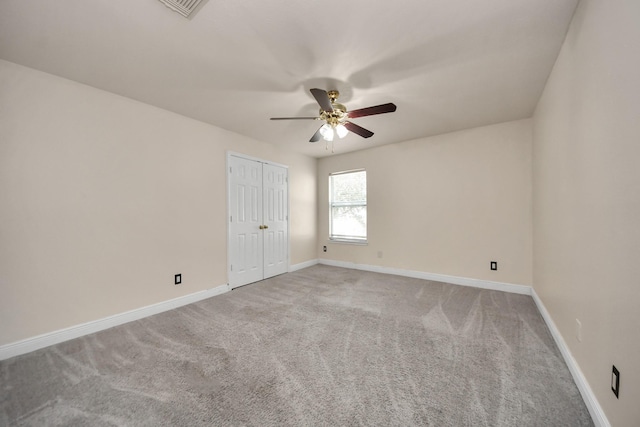 spare room with carpet floors and ceiling fan