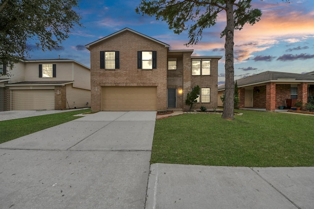 view of front of house featuring a garage and a yard