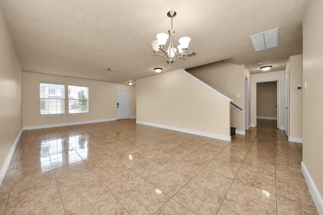 spare room with a chandelier