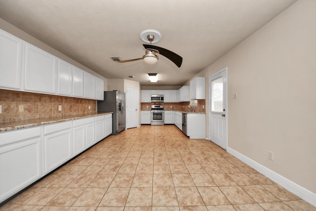 kitchen featuring light tile patterned floors, ceiling fan, backsplash, stainless steel appliances, and white cabinets