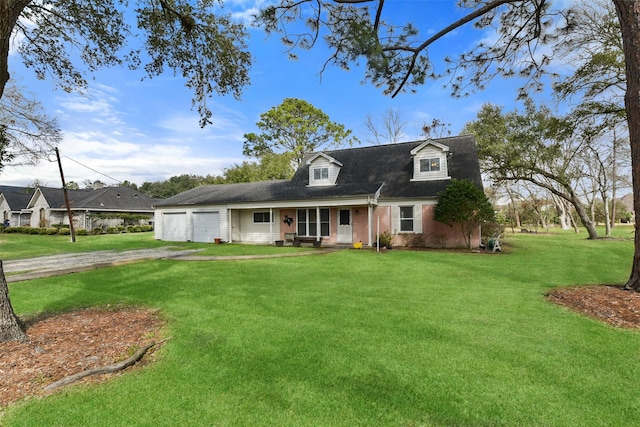 cape cod home featuring a garage and a front yard