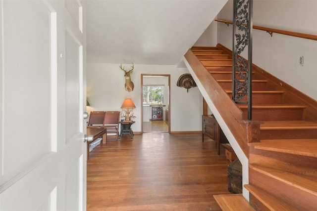 stairway featuring wood-type flooring