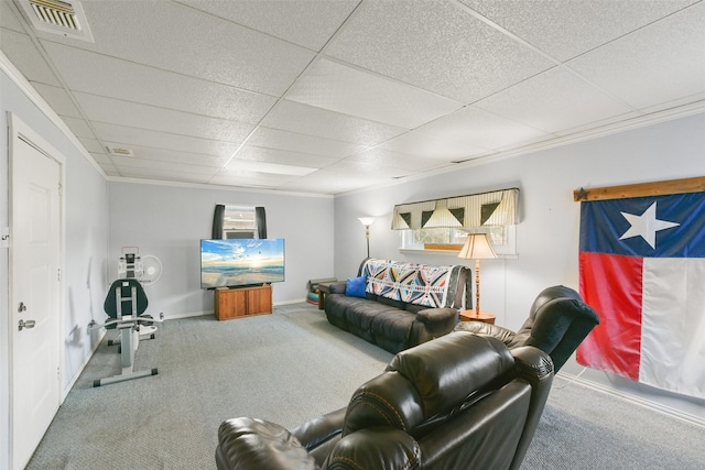 living room featuring a drop ceiling, carpet floors, and ornamental molding