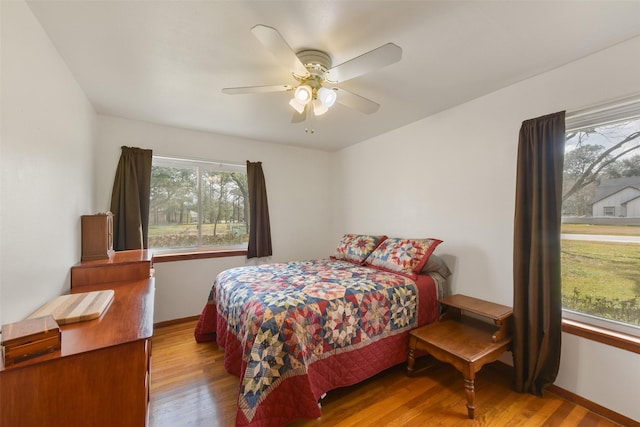 bedroom with hardwood / wood-style floors and ceiling fan