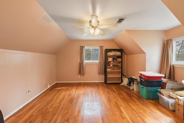 additional living space featuring lofted ceiling, light hardwood / wood-style flooring, and ceiling fan