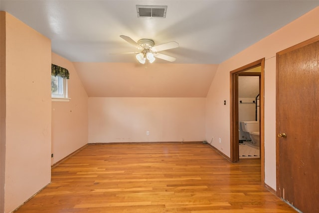 additional living space featuring ceiling fan, vaulted ceiling, and light hardwood / wood-style flooring