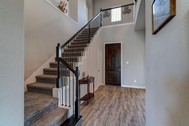 foyer featuring hardwood / wood-style floors and a high ceiling