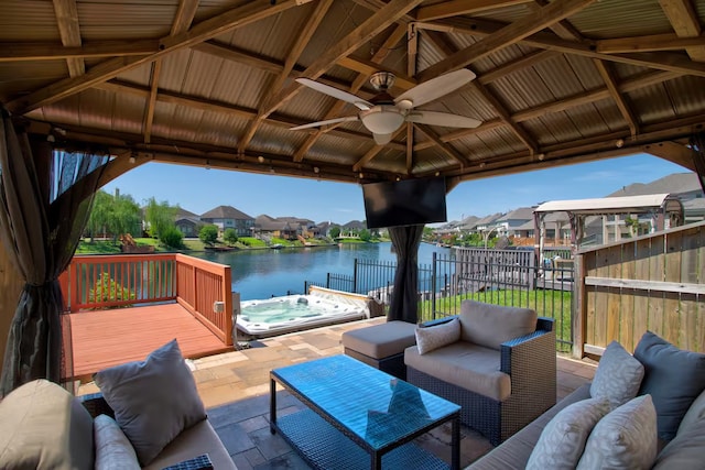 view of patio with a gazebo, ceiling fan, a hot tub, and an outdoor hangout area