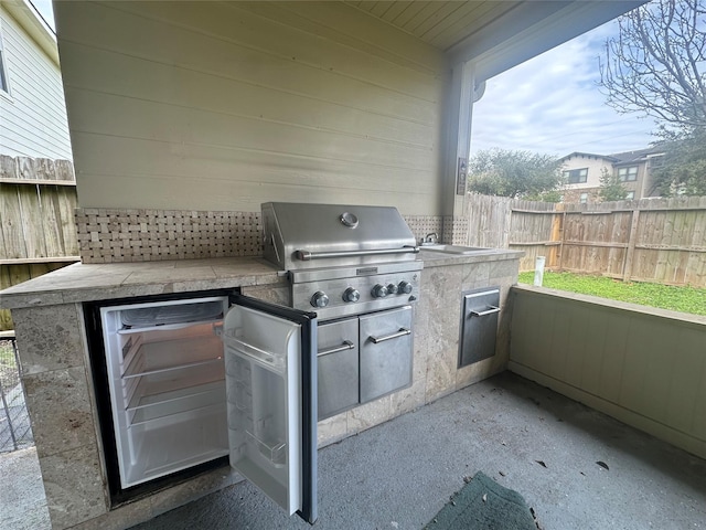 view of patio with grilling area and an outdoor kitchen