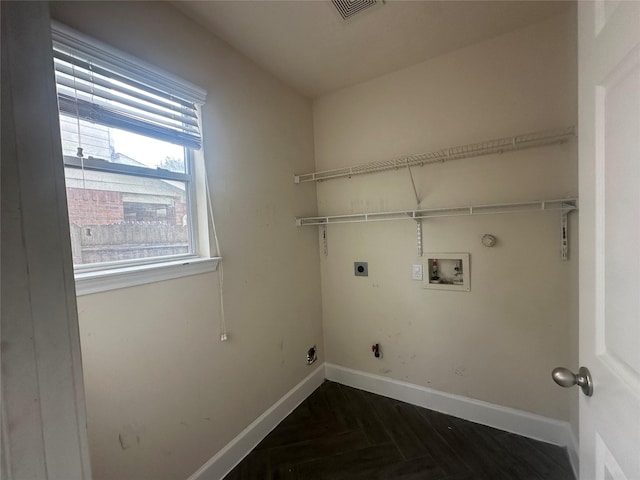 laundry room with dark parquet flooring, hookup for a gas dryer, hookup for a washing machine, and electric dryer hookup