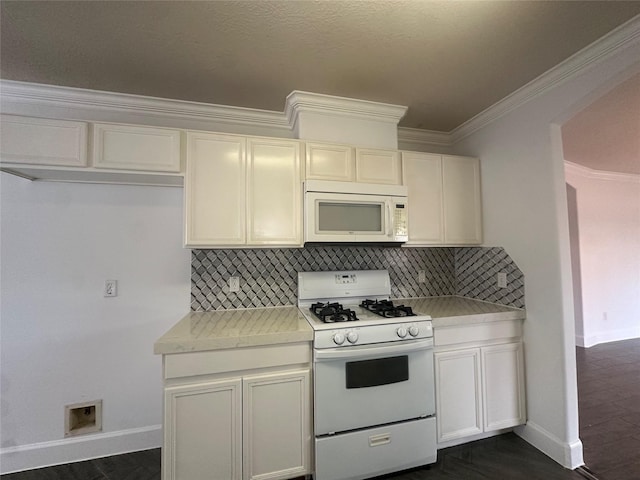 kitchen with crown molding, white appliances, dark hardwood / wood-style floors, and decorative backsplash