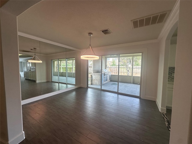 unfurnished dining area featuring ornamental molding and dark hardwood / wood-style flooring