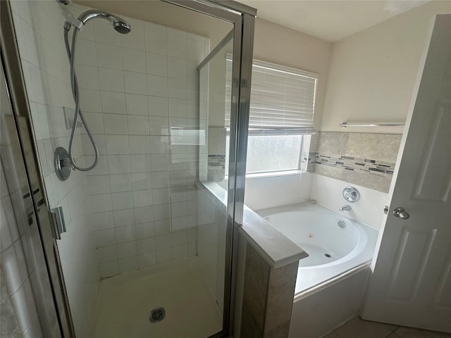 bathroom with separate shower and tub and tile patterned floors