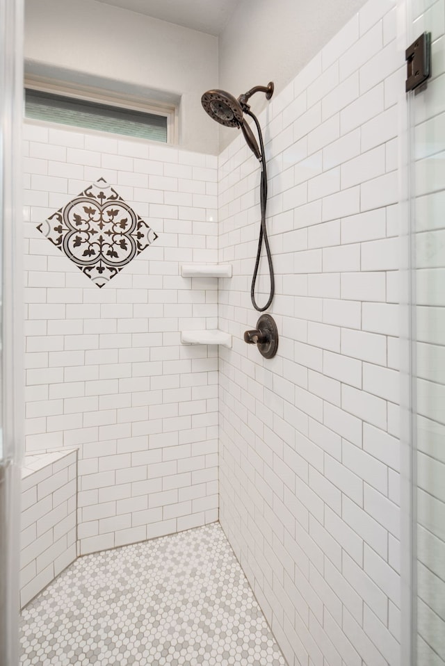 bathroom with tiled shower