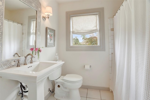 bathroom with tile patterned flooring, walk in shower, and toilet