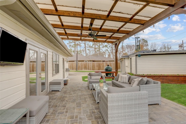 view of patio with ceiling fan, grilling area, a storage unit, and outdoor lounge area