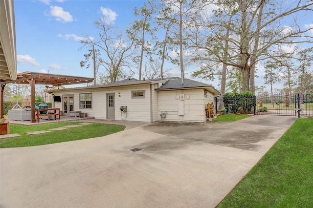 back of house featuring a yard and a patio area