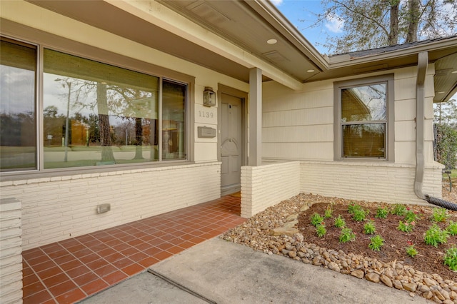 view of exterior entry featuring a patio