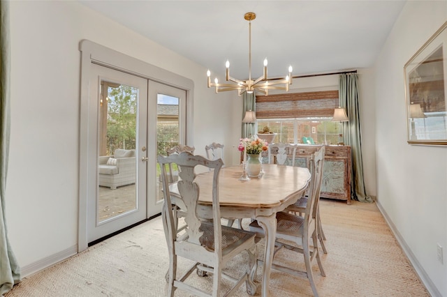 dining area featuring light colored carpet, a notable chandelier, and french doors